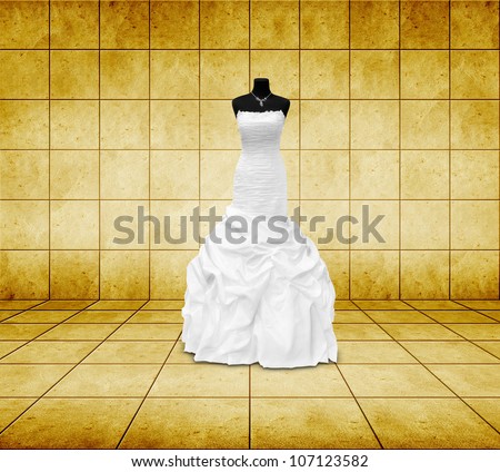 wedding dress on a mannequin in golden room
