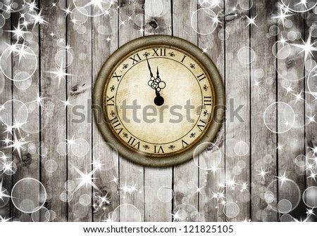 Vintage clock on the brown wood texture with white snow and stars. Christmas background