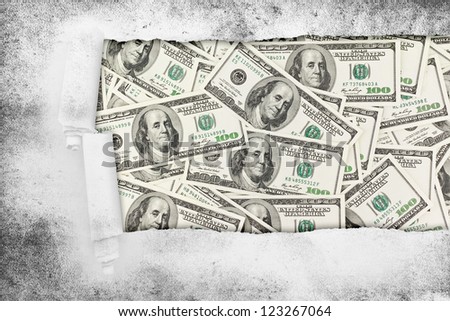 Closeup of a hole in paper over money american hundred dollar bills. Business background