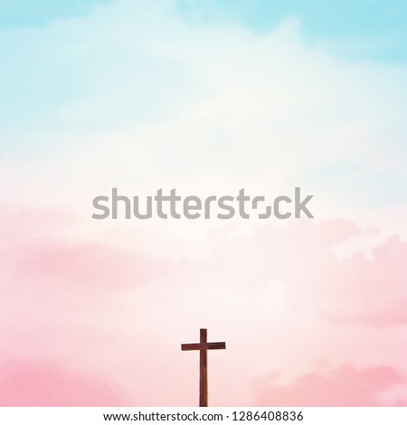Wooden cross over abstract sky background. Christian concept