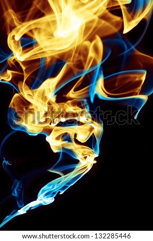 Abstract blue and yellow flame on black background