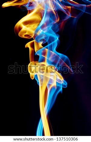 Abstract blue and yellow smoke with over black background