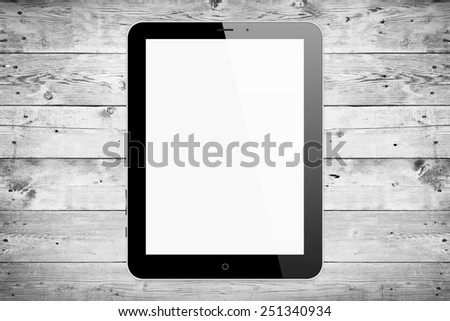 Black tablet pc on wood background