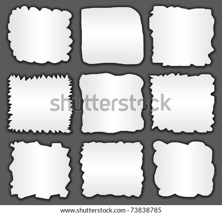 collection of white ripped pieces of paper on black
