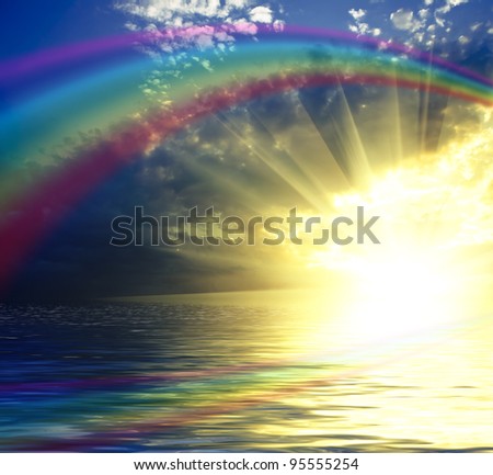 Sky background with rainbow and reflection in water. Sunset