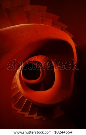Red stone spiral stairs looking down the middle