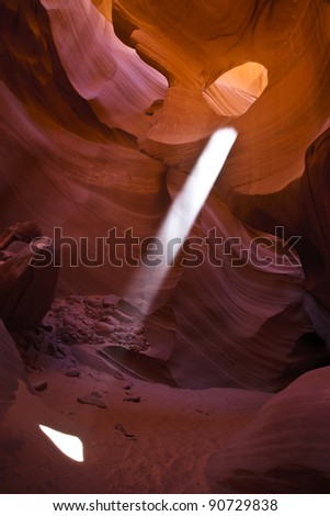 A ray of light streams from The Eye in Antelope Canyon
