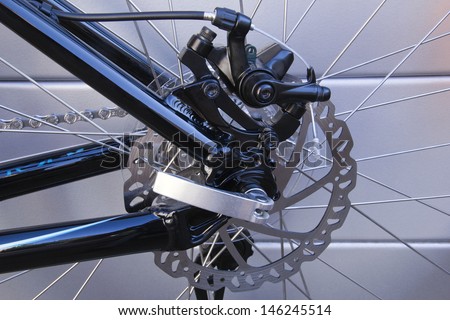 bicycle disk brake on a grey background