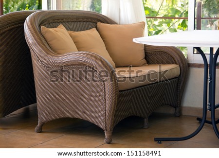 A place to relax with a sofa made Ã?Â¢??Ã?Â¢??of straw, pillows and table