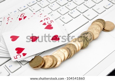 Poker, money and computer keyboard (the expression of an online poker game, or against the concept of online gambling)