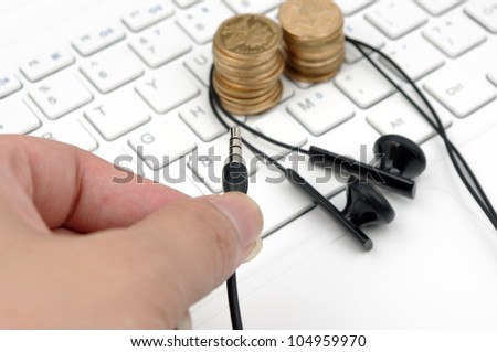 Keyboard headset and money (to express the concept of a paid download and listen to music)