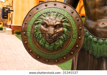 A warrior\'s shield with the Roman insignia - the lion\' s head.