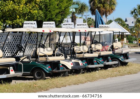 Row of electric touring carts in Cedar Key, Florida.