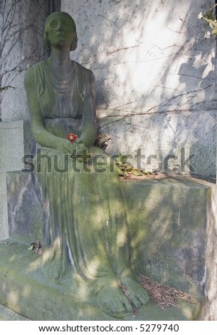 Statue of a mourning woman in an old German cemetery