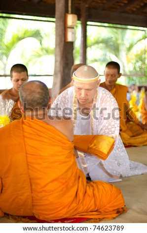 SURATTHANI, THAILAND - MARCH 5:  The Naga (called person before as monk) is receiving the yellow robe in Buddhist ordination ceremony on March 5, 2011 in the Phunphin Temple, southern Thailand