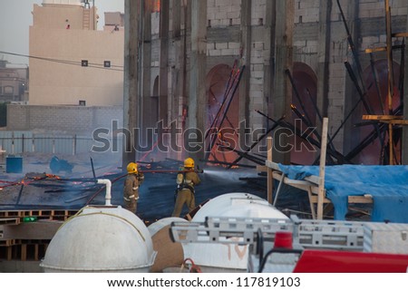MANGAF, KUWAIT - AUGUST 13: Two firefighters extinguishes a building on fire on August 13, 2009 in Mangaf, Kuwait.