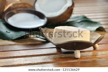 soap and milk with coconut arranged on a wooden bench