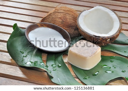 soap and milk with coconut arranged on a wooden bench