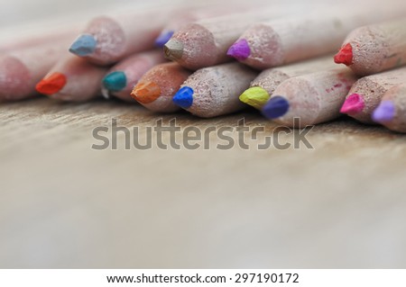 colorful lead pencils on wooden background