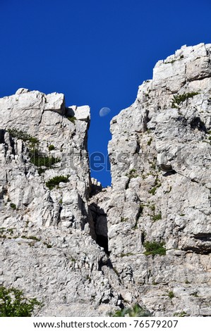moon between rock walls