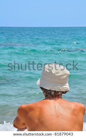 man back in front of a blue sea