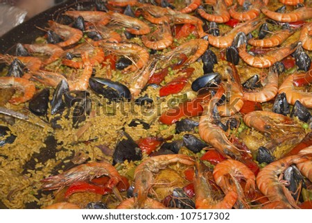 Seafood Paella in large frying pan. Fast food. (Arles, France)