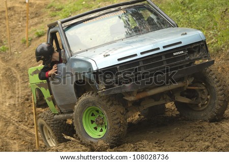 MOHELNICE, CZECH REPUBLIC - JUNE 10. Unidentified racer at blue off-road car on a steep slope in the \