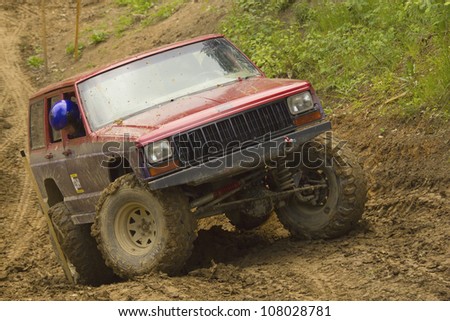 MOHELNICE, CZECH REPUBLIC - JUNE 10. Unidentified racer at red off-road car on a steep slope in the \