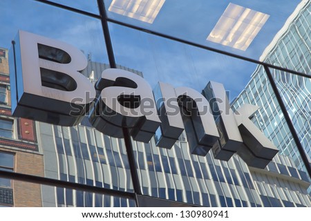 The glass wall of the building with the inscription Bank