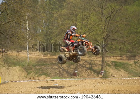 MOHELNICE,  CZECH REPUBLIC - APRIL 19: Racer in red is jumping a quad motorbike in the \