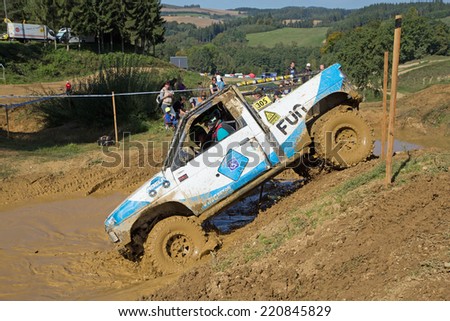 MOHELNICE,  CZECH REPUBLIC - SEPT 28: White off road car pulls into the deep mud in the BIG SHOCK! CUP of the Czech Republic. On September 28, 2014  in MOHELNICE, Czech Republic.