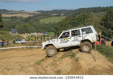 MOHELNICE,  CZECH REPUBLIC - SEPT 28: White off road car is hitting a steep hill in the BIG SHOCK! CUP of the Czech Republic. On September 28, 2014  in MOHELNICE, Czech Republic.