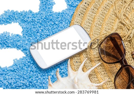 Straw hat, sunglasses and a seashell are lying on a little blue stones forming a wave isolated on the white. Display of the cell phone is  ready for your text. All potential trademarks are removed.