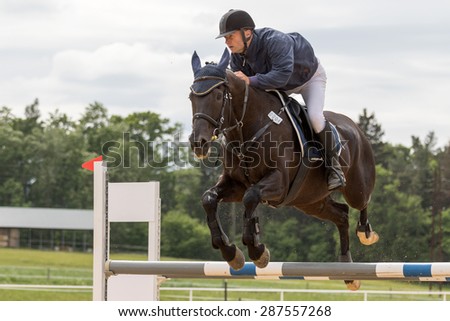 SVEBOHOV, CZECH REPUBLIC - MAY 23: Closeup view of horseman during the jump on a horse at \