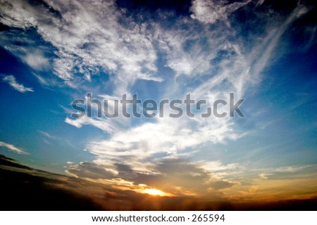 Sunset and blue sky with white clouds. Wide angle lens gives a sense of depth. Landscape format