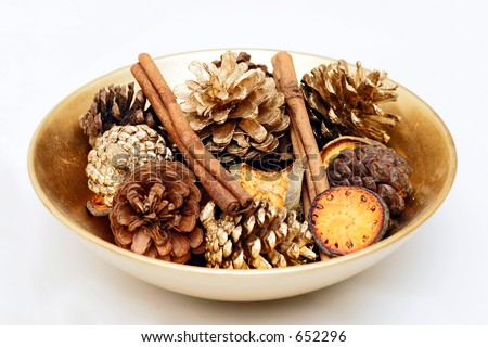 A decorative bowl with gold sprayed organic and natural items