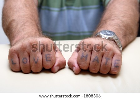 Thug hands with stereotypical love and hate tattooed on fingers