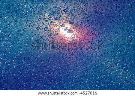 Sun shining through a wet parasol after a rain storm