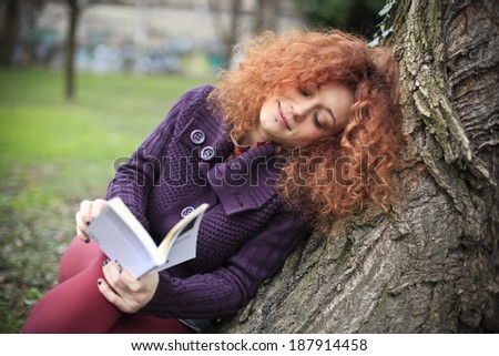 Student reads a book at the park