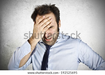 Stressed businessman with hand on the head