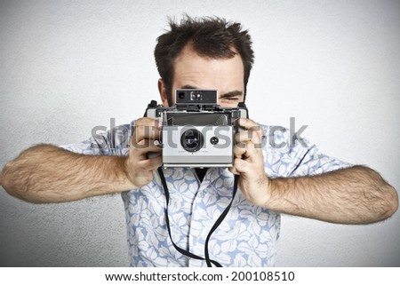 Tourist taking a picture with vintage camera