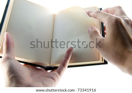 Opened book in hand