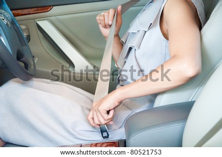 business woman putting safety belt