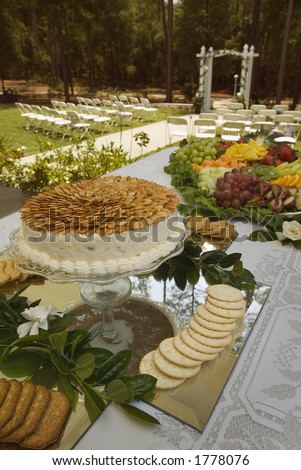 Wedding buffet food with chairs and aisle in background