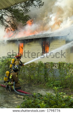 Firefighters battle house on fire