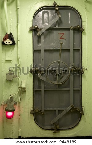 Locked ship hatch metal door at end of hallway navy