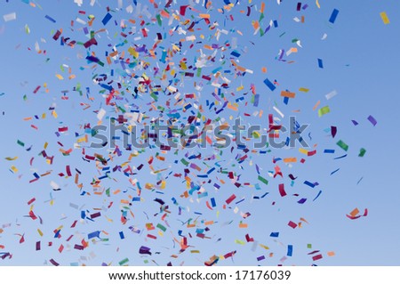 Confetti paper filled colorful blue sky background