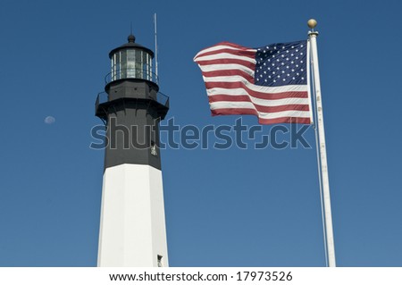 Tybee black and white navigational lighthouse in Georgia GA with USA flag