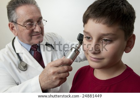 Doctor physician gives boy physical exam