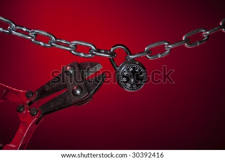 cutting open chain lock on red background